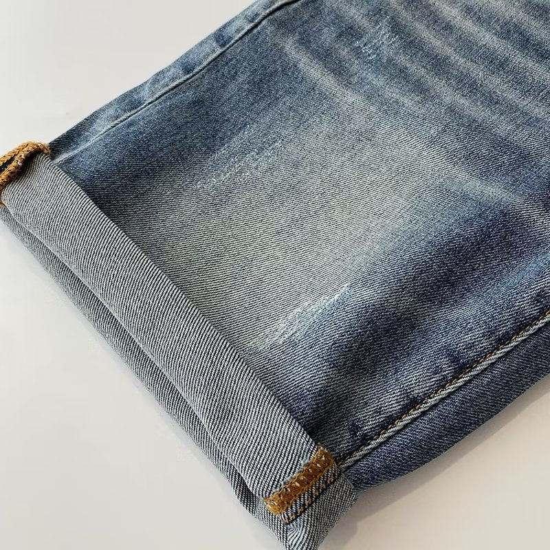 Pantalon mi-long simple et polyvalent, en jean bleu délavé, coupe décontractée pour homme.