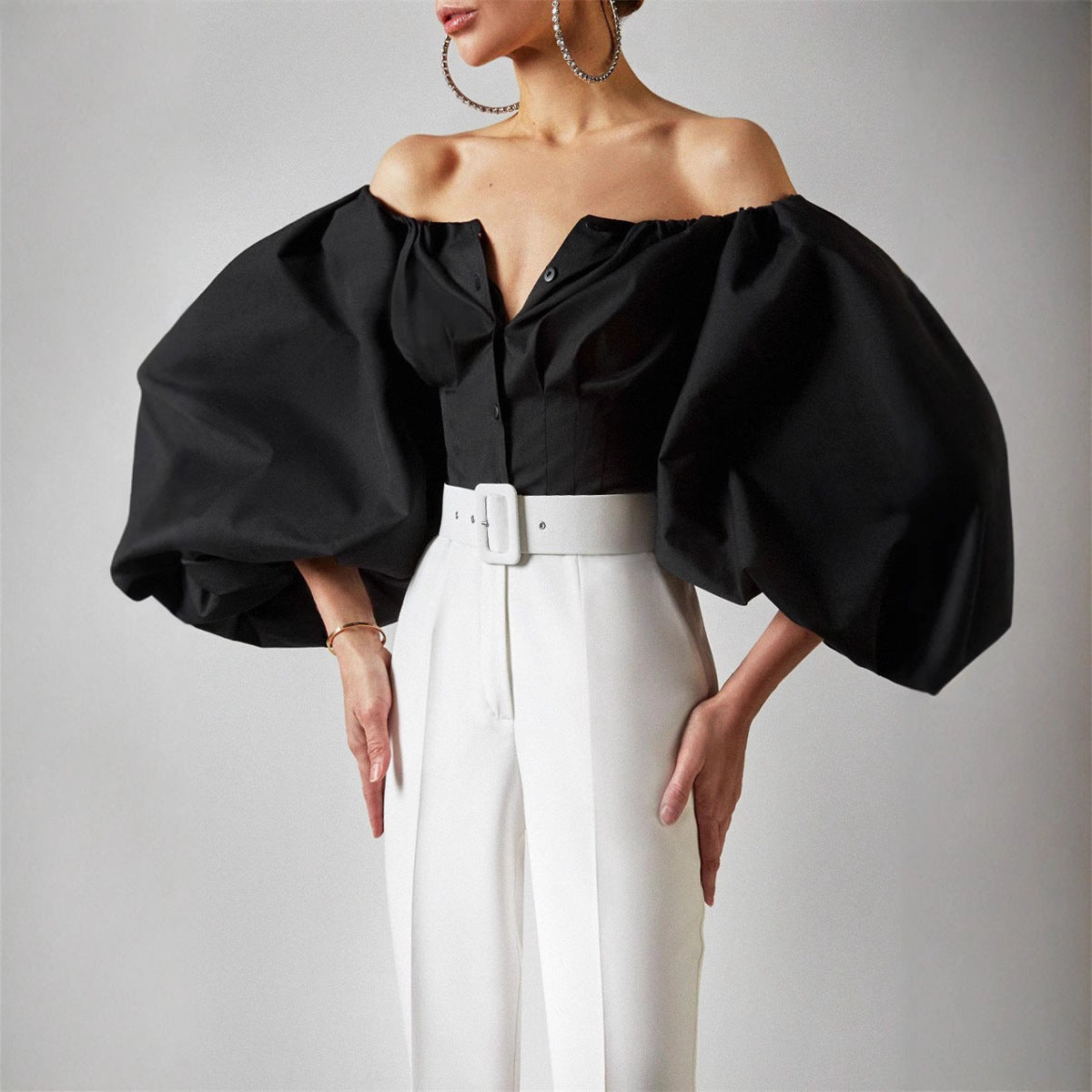 Cross-border 2022 spring and summer new design sense long sleeve bubble balloon sleeve leaky shoulder European and American women's shirt top top
